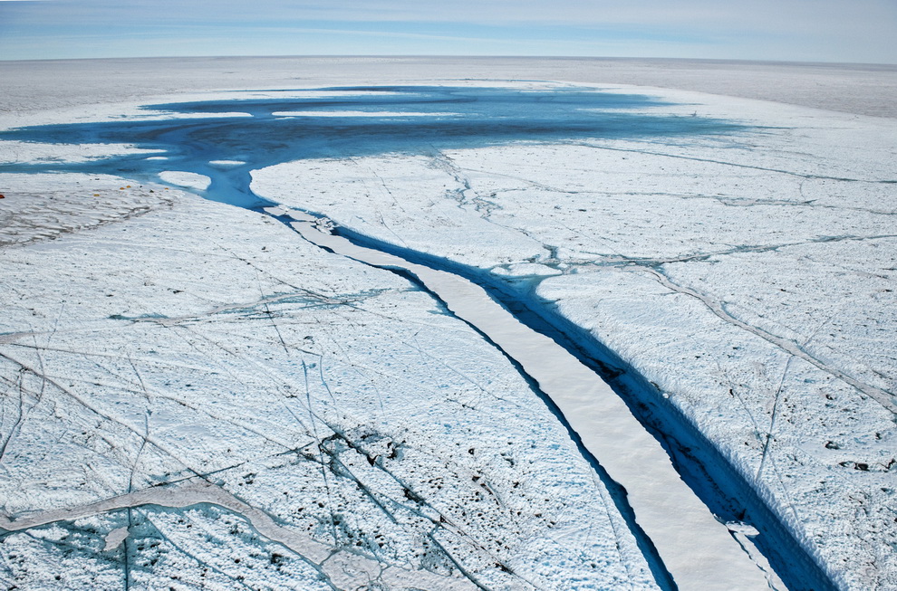 Summer meltwater has drained through a snow-covered channel.