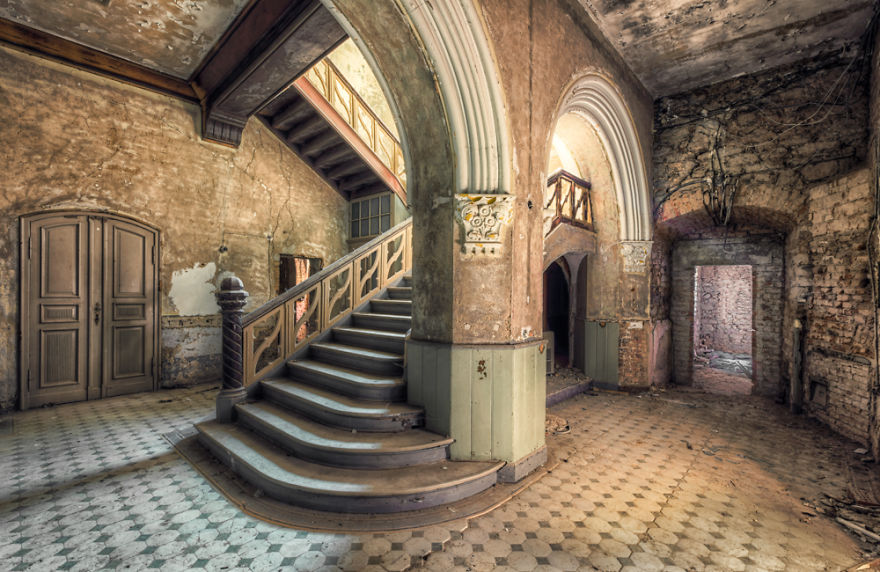 old abandoned staircase with pillar and arch