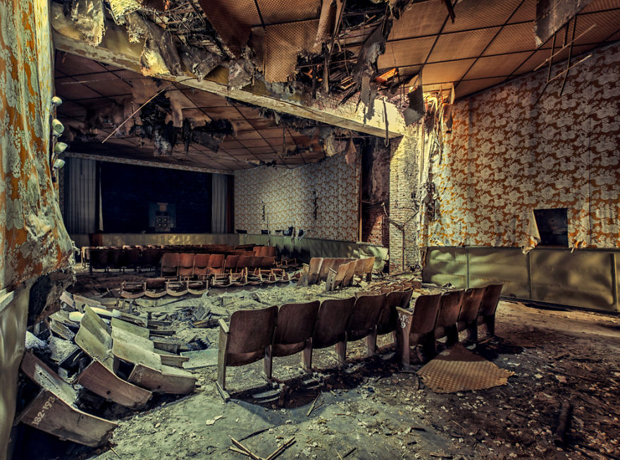 abandoned Cinema with wooden chairs