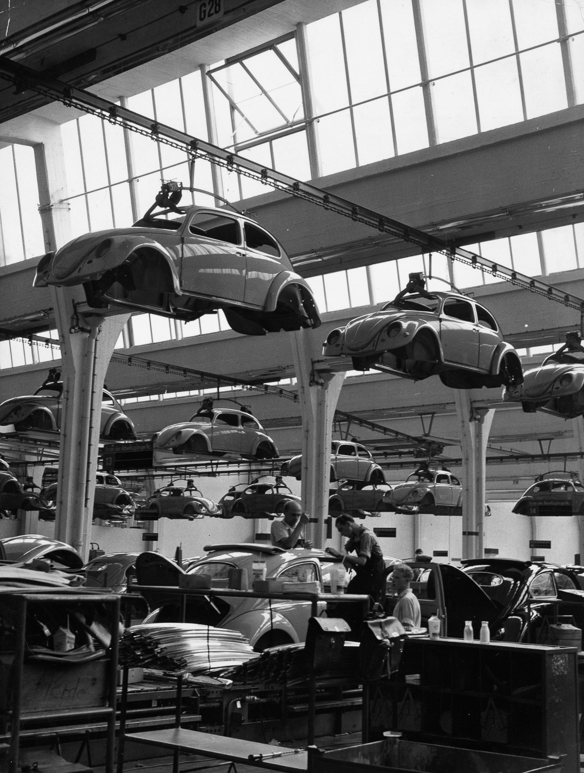circa 1955: Workers on the production line of a Volkswagen factory at work on Beetles. (Photo by Keystone/Getty Images)