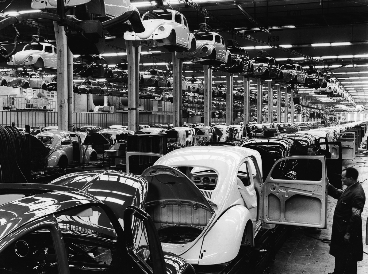An employee at a Volkswagen plant work inspects a Volkswagen 1200 Sedan, better known as a Beetle, on the assembly line, Wolfsburg, Germany, 1960s. (Photo by Pictorial Parade/Getty Images)