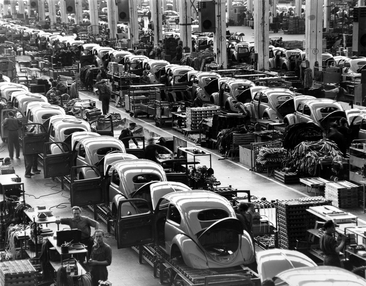 FILE - In this June 16, 1954 file photo, VW beetles are assembled in lines at the Volkwagen auto works plant, which manufactures nearly 900 automobiles each day, in Wolfsburg, West Germany. Thanks to Volkswagen, Wolfsburg boomed in West Germany’s postwar rebirth and today the town and the company are inseparable. (AP Photo/Reithausen, File)